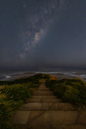Long reef headland view at night with milky way galaxy.の写真素材