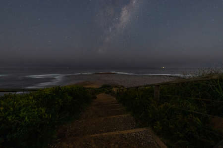 Stair to the sea with milky way galaxy.の写真素材