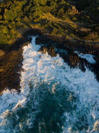Rough ocean water around the rocky coastline.の写真素材