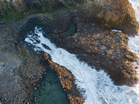 Top down view of wave water between rock channel.の写真素材