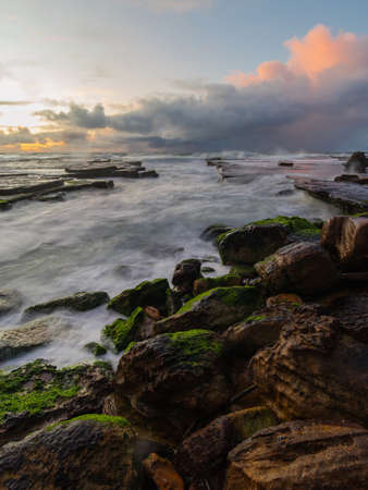 Rocky ocean coastline with wave water.の写真素材