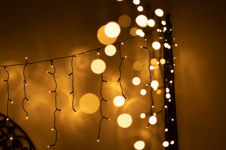 Led yellow lights close up. New year and Christmas home decorations. Warm yellow colour . Abstract bokehの写真素材