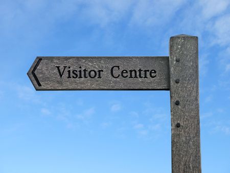 A Wooden Sign for a Visitor Centre with Blue Sky.の写真素材