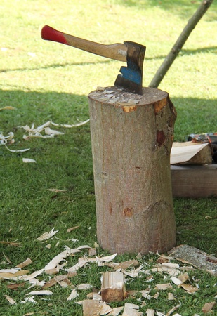 A Hand Axe Placed in a Wooden Chopping Block.の写真素材