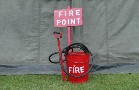 A Vintage Fire Point with a Bucket Hose and Pump.