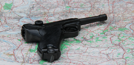A Vintage Wartime Hand Gun on a Detailed Location Map.のeditorial素材