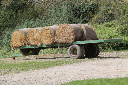 An Agricultural Farm Flat Bed Trailer with Hay Bales.