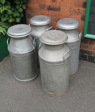 Four Vintage Metal Milk Churns Ready for Collection.の写真素材