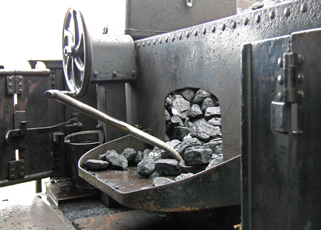 A Shovel and Coal on a Vintage Railway Steam Engine.