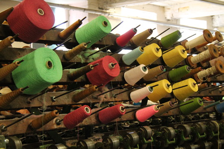 Reels of Coloured Cotton on a Vintage Textile Machine.