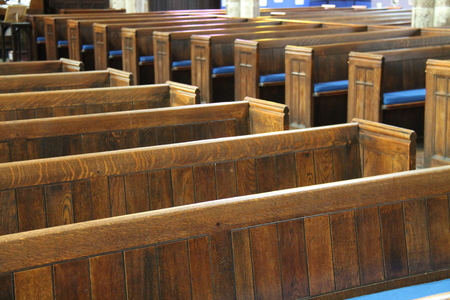 Rows of Traditional Wooden Pew Seats in a Church.
