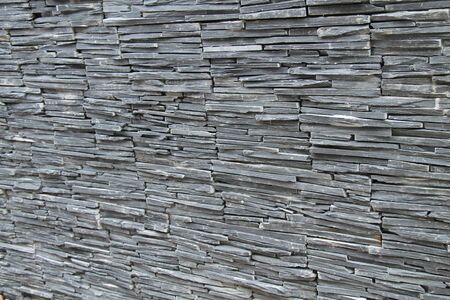 A Background Image of a Stone Slate Built Wall.の写真素材