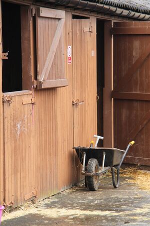 A Mucking Out Wheelbarrow at a Horse Stables.の写真素材