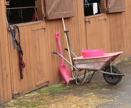 Tools and Wheelbarrow for Mucking Out Horse Stables.の写真素材