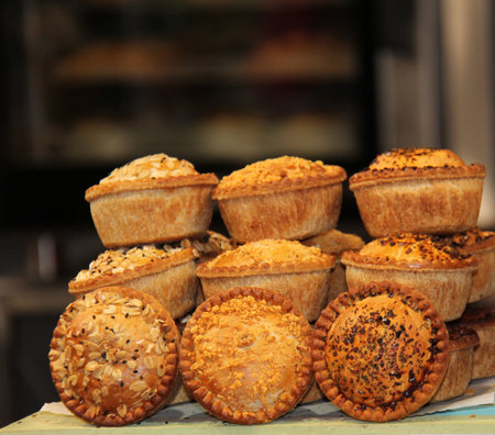 A Variety of Different Topped Freshly Made Pork Pies.