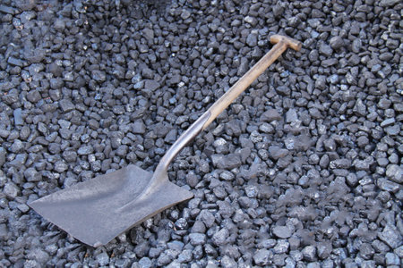 A Hand Shovel on a Pile of Traditional Coal Boiler Fuel.の写真素材