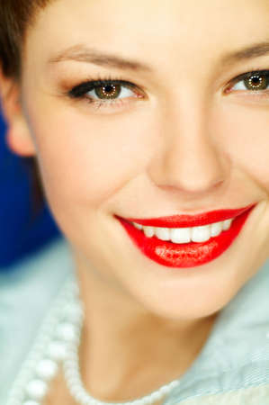 Portrait of beautiful young  smiling woman with red lipstickの写真素材