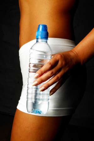 Woman's body part with bottle of water