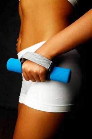 Woman's body part with fitness dumbell