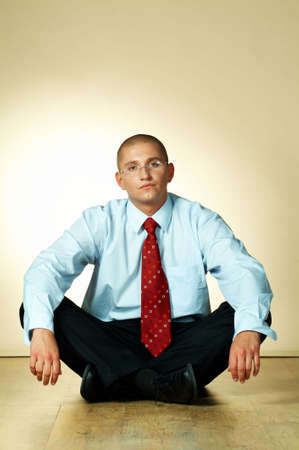 A businessman is sitting on wooden floorの写真素材