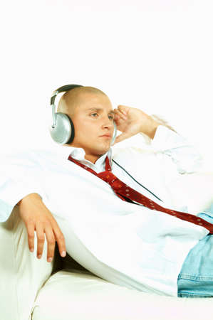 Businessman relaxing on couch and listen to music