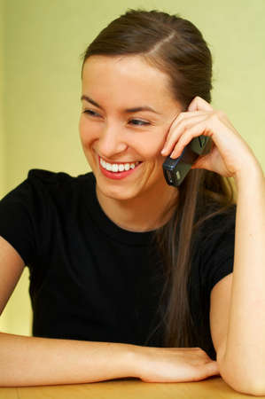 Young woman talking by cell phoneの写真素材