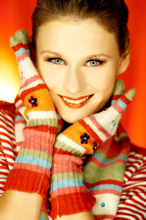 Portrait of attractive beautiful young woman wearing gloves and scarfの写真素材