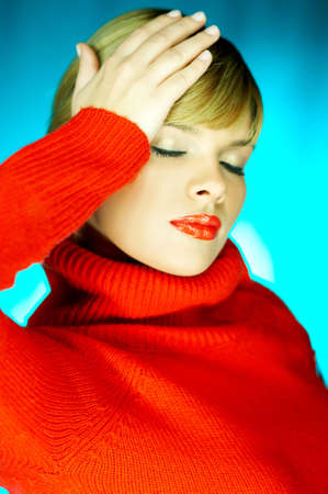 Portrait of beautiful woman wearing red sweaterの写真素材