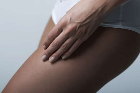 Beautiful womans body part wearing white underwear on clear backgroundの写真素材