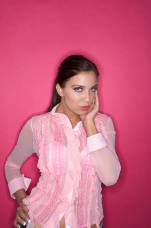 Portrait of Young woman isolated on pink backgroundの写真素材