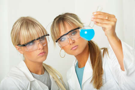 Female lab workers testing and experimentingの写真素材