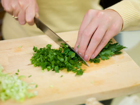 Beautiful woman in kitchen holding yellow pepperの写真素材