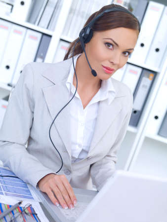Business woman working in office, wearing headset