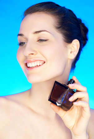 Portrait of 20-25 years old beautiful woman with bottle of perfume