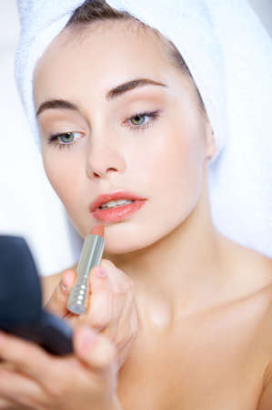 Portrait of cute teenage girl doing morning makeupの写真素材