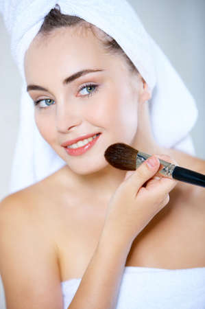 Portrait of cute teenage girl doing morning makeupの写真素材