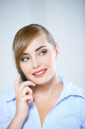 Portrait of beautiful business woman using mobile phoneの写真素材