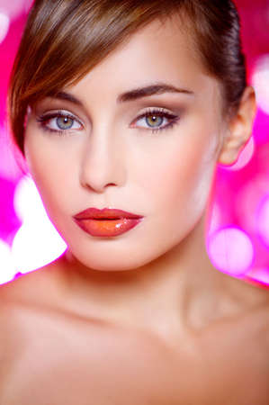 Portrait of beautiful young sexy woman on red backgroundの写真素材