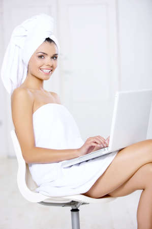 Portrait of beautiful woman working on laptop computerの写真素材