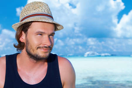 Handsome man resting near water at Maldivesの写真素材
