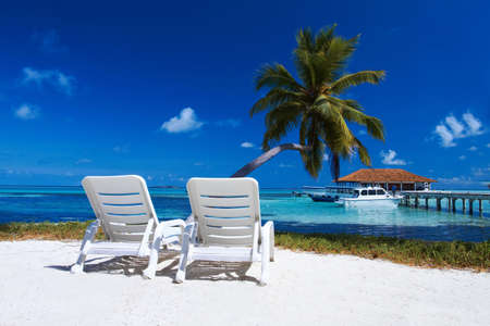 Two sun beds on beautiful beach at Maldivesのeditorial素材