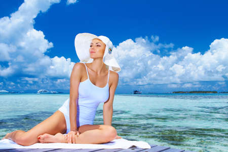 Beautiful woman resting near water at Maldivesの写真素材