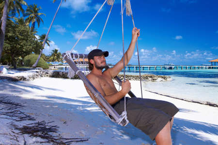 Handsome man resting near water at Maldivesの写真素材