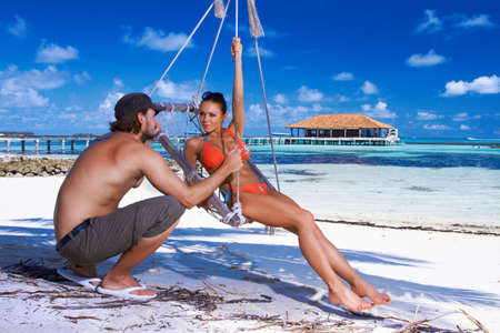 Romantic couple resting at Maldives seasideの写真素材