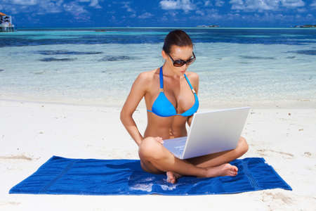 Beautiful woman resting near water at Maldivesの写真素材