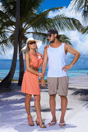 Romantic couple standing next to palm treeの写真素材