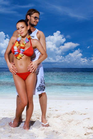 Romantic couple resting at Maldives seasideの写真素材