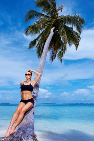 Beautiful woman resting on beach at Maldivesの写真素材