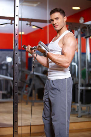 Handsome man at the gym doing exercisesの写真素材