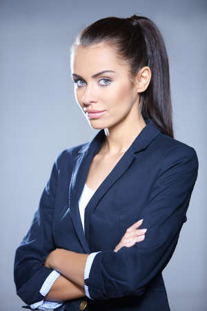 Portrait of beautiful business woman on gray backgroundの写真素材